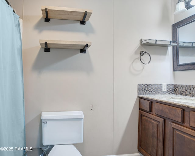1406 S Patout St, New Iberia, LA 70560 - full bathroom with vanity, backsplash, and toilet
