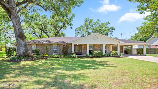 200 Sandager Ave, Jeanerette, LA 70544 - view of front of house featuring concrete driveway, a carport, a front lawn, a porch, and fence