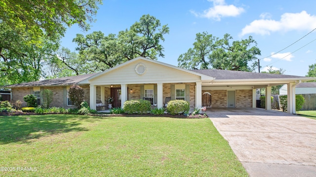 200 Sandager Ave, Jeanerette, LA 70544 - ranch-style house featuring a front yard, fence, an attached carport, and concrete driveway