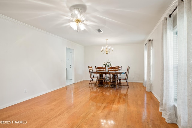 200 Sandager Ave, Jeanerette, LA 70544 - dining room featuring crown molding, an inviting chandelier, visible vents, and light wood-type flooring