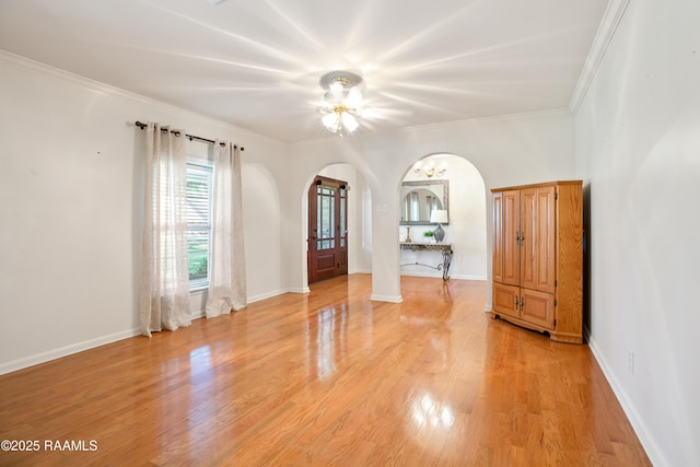 200 Sandager Ave, Jeanerette, LA 70544 - unfurnished room with baseboards, arched walkways, light wood-type flooring, and ornamental molding