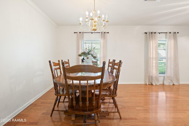 200 Sandager Ave, Jeanerette, LA 70544 - dining room featuring ornamental molding, baseboards, a chandelier, and light wood-style floors
