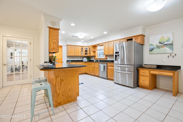 200 Sandager Ave, Jeanerette, LA 70544 - kitchen featuring ornamental molding, a peninsula, dark countertops, appliances with stainless steel finishes, and a sink