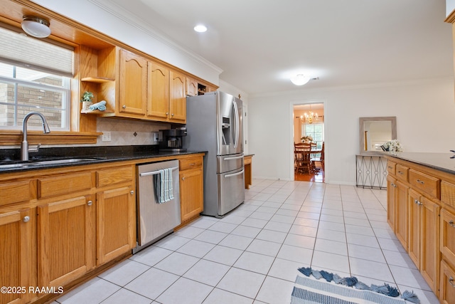 200 Sandager Ave, Jeanerette, LA 70544 - kitchen with light tile patterned floors, a sink, appliances with stainless steel finishes, crown molding, and backsplash