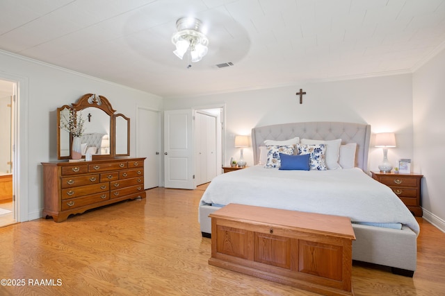 200 Sandager Ave, Jeanerette, LA 70544 - bedroom with ensuite bath, light wood-style flooring, visible vents, and ornamental molding