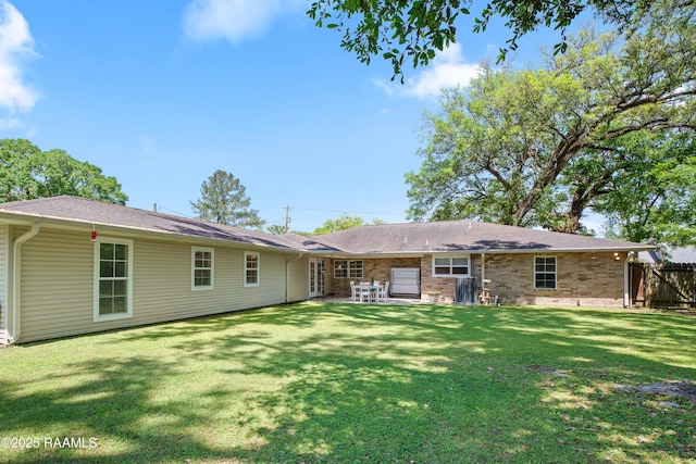 200 Sandager Ave, Jeanerette, LA 70544 - rear view of property featuring a patio, fence, and a lawn