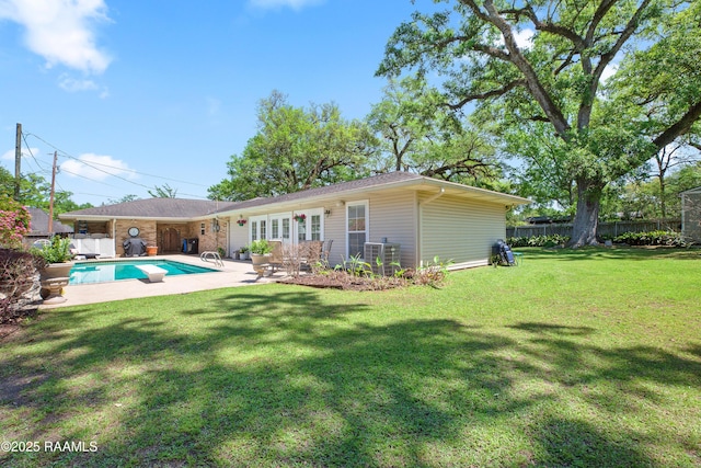 200 Sandager Ave, Jeanerette, LA 70544 - rear view of house featuring a fenced in pool, a patio area, fence, and a lawn
