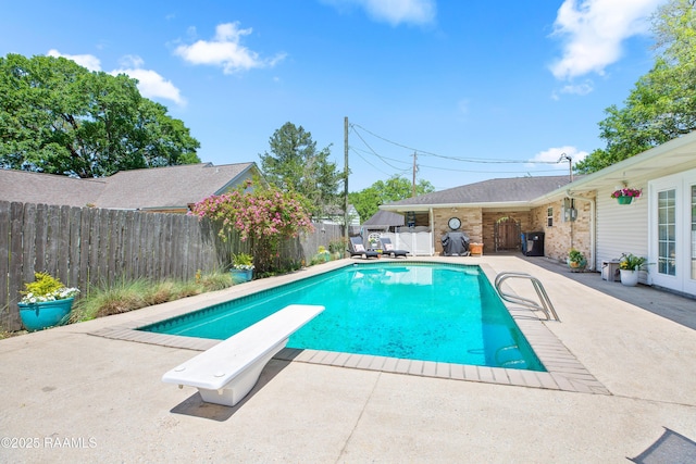 200 Sandager Ave, Jeanerette, LA 70544 - view of pool featuring a diving board, a fenced backyard, a patio area, french doors, and a fenced in pool