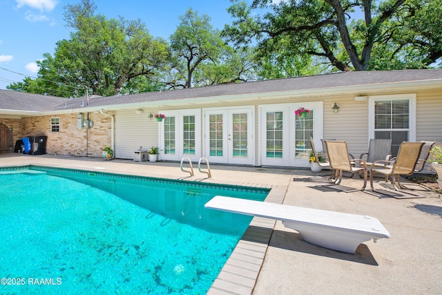 200 Sandager Ave, Jeanerette, LA 70544 - outdoor pool featuring a patio, french doors, and a diving board