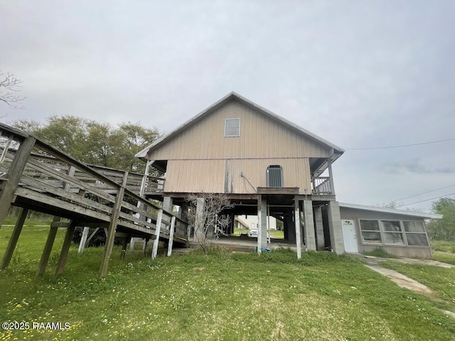 back of house featuring a yard, a deck, and stairway