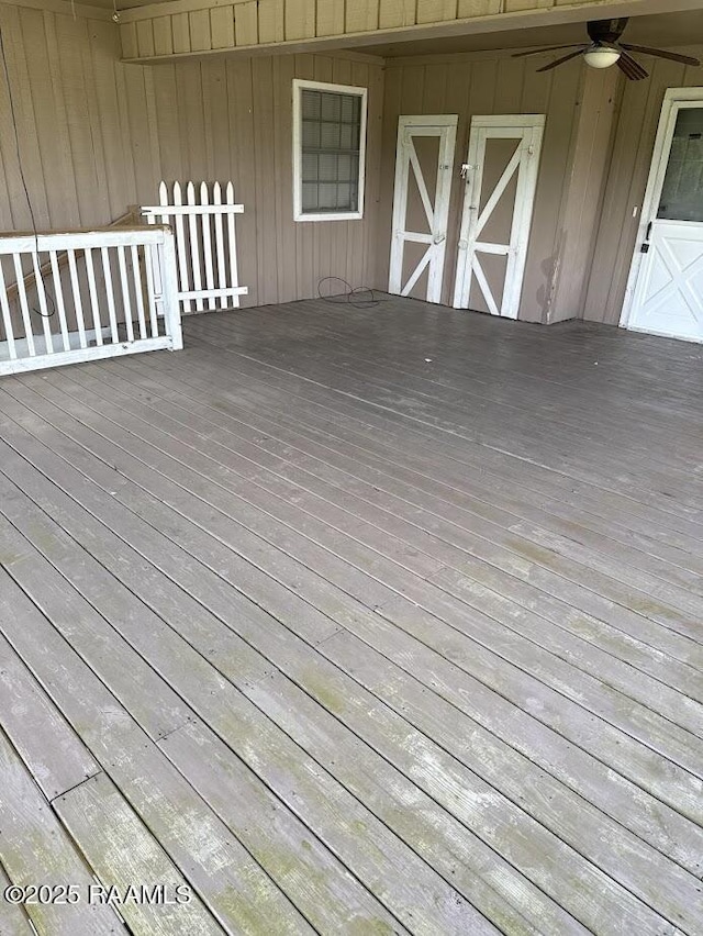wooden deck with a ceiling fan