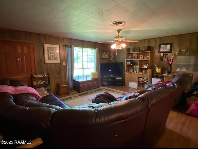 207 Menard Rd, Sunset, LA 70584 - living area with wooden walls, ceiling fan, and light wood-style flooring