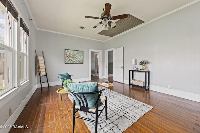 sitting room with ornamental molding, visible vents, ceiling fan, and wood finished floors