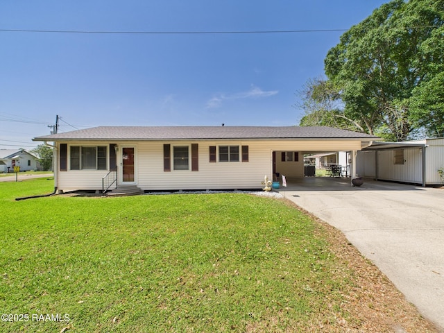 single story home with concrete driveway, a front lawn, an attached carport, and entry steps