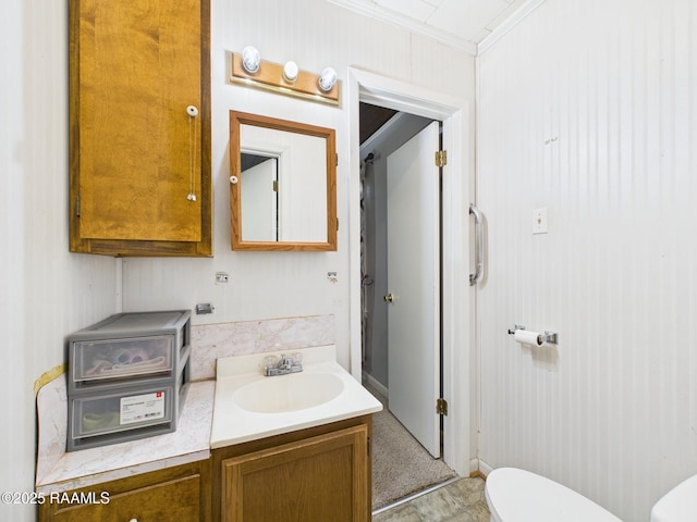 bathroom with vanity, ornamental molding, and toilet