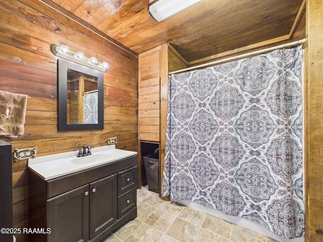 bathroom with curtained shower, wooden walls, vanity, and wooden ceiling