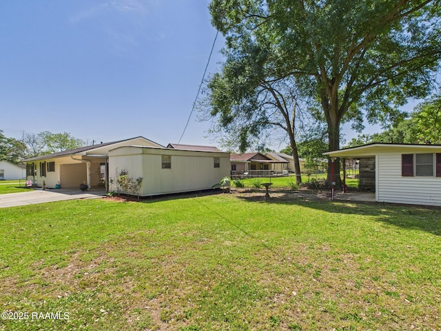 view of yard with driveway and fence