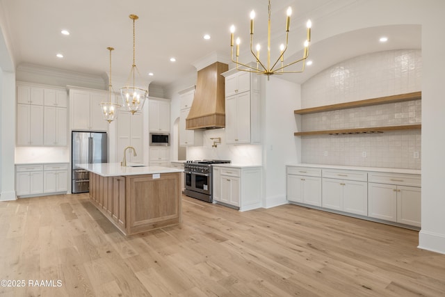 207 Sunset Palm Ct, Youngsville, LA 70592 - kitchen featuring appliances with stainless steel finishes, a chandelier, light countertops, custom range hood, and tasteful backsplash