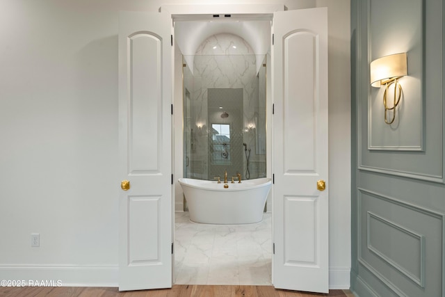 207 Sunset Palm Ct, Youngsville, LA 70592 - bathroom featuring a marble finish shower, marble look tiles, and a freestanding tub