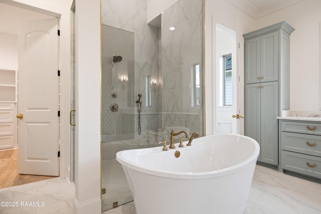 207 Sunset Palm Ct, Youngsville, LA 70592 - bathroom featuring marble look tile flooring, a soaking tub, a marble finish shower, vanity, and crown molding