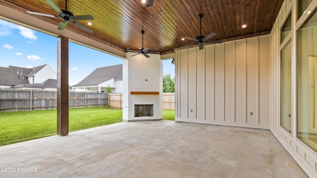207 Sunset Palm Ct, Youngsville, LA 70592 - fenced backyard featuring an outdoor brick fireplace, a ceiling fan, and a patio area