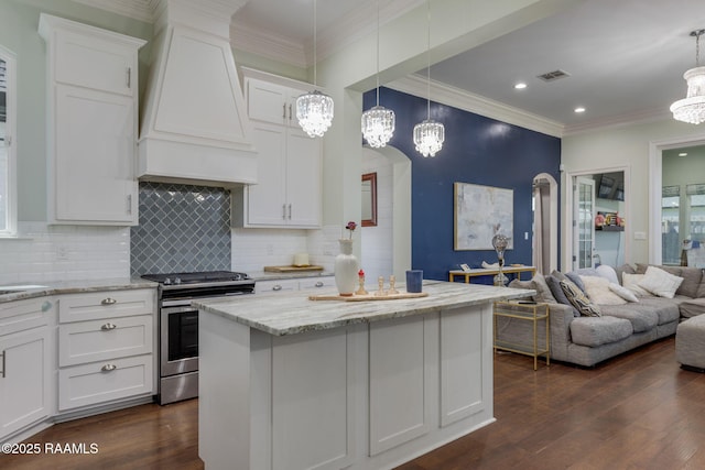 208 Woodstone Dr, Lafayette, LA 70508 - kitchen with custom range hood, white cabinetry, a chandelier, and stainless steel range with electric stovetop