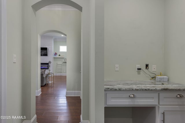 208 Woodstone Dr, Lafayette, LA 70508 - hall with arched walkways, dark wood-style flooring, baseboards, and ornamental molding