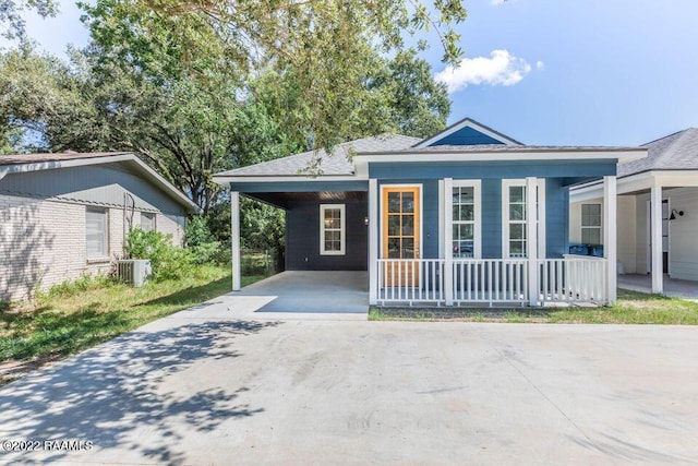 122 Rena Dr Unit A, Lafayette, LA 70503 - view of front of home with roof with shingles, a carport, central AC unit, covered porch, and driveway