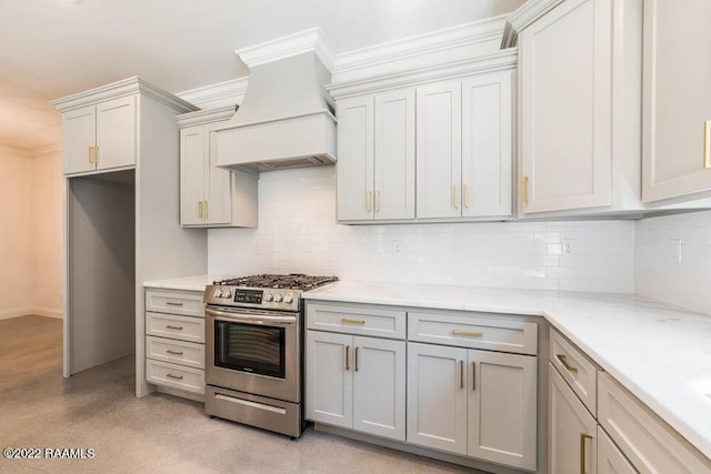 122 Rena Dr Unit A, Lafayette, LA 70503 - kitchen featuring crown molding, gas stove, premium range hood, backsplash, and gray cabinetry