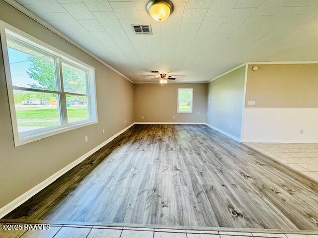 336 Harmon Ln, Opelousas, LA 70570 - empty room with ornamental molding, wood finished floors, baseboards, and ceiling fan