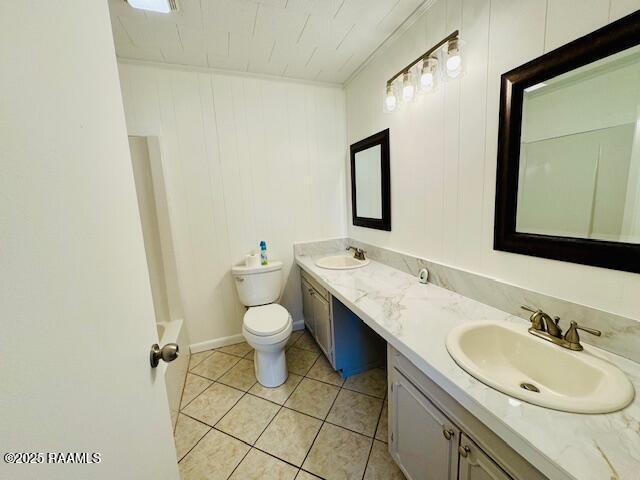 336 Harmon Ln, Opelousas, LA 70570 - full bathroom with double vanity, toilet, and tile patterned floors