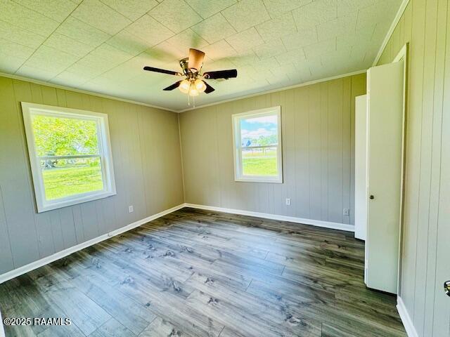 336 Harmon Ln, Opelousas, LA 70570 - unfurnished room with crown molding, wood finished floors, a ceiling fan, and baseboards
