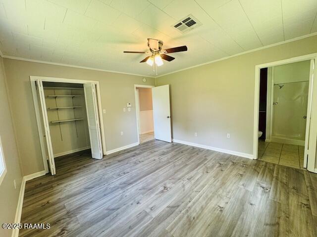 336 Harmon Ln, Opelousas, LA 70570 - unfurnished bedroom with crown molding, wood finished floors, a closet, baseboards, and ceiling fan