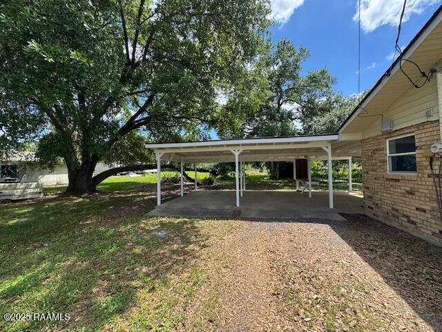 336 Harmon Ln, Opelousas, LA 70570 - view of vehicle parking with a carport