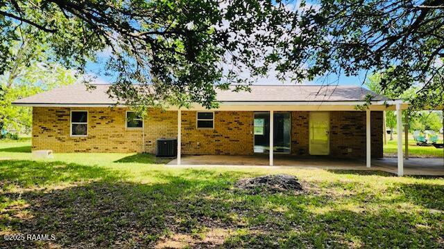 336 Harmon Ln, Opelousas, LA 70570 - back of house with a yard and brick siding