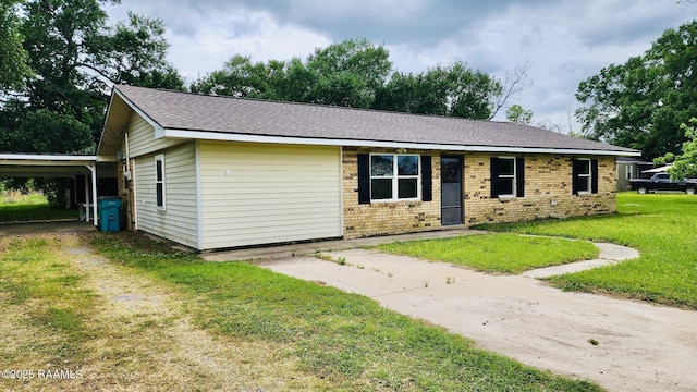 336 Harmon Ln, Opelousas, LA 70570 - view of front of home featuring driveway, a front lawn, and brick siding