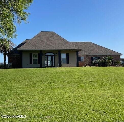 view of front of home featuring a front lawn and stucco siding