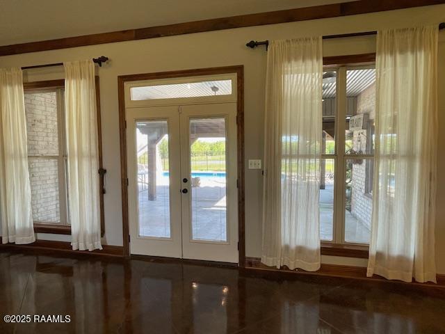doorway featuring french doors and baseboards