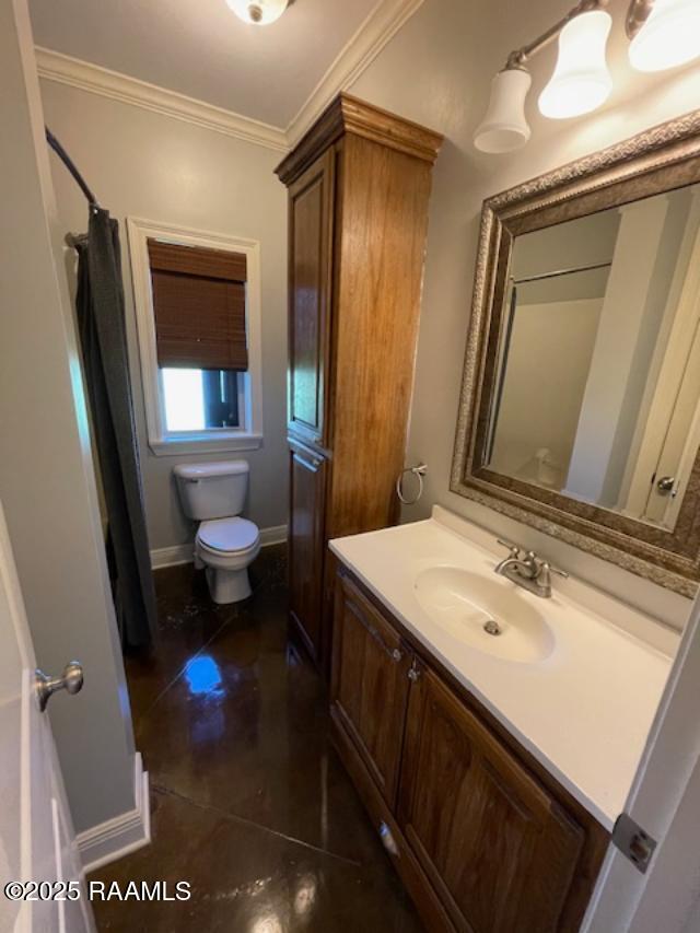 full bath with toilet, crown molding, vanity, tile patterned floors, and baseboards