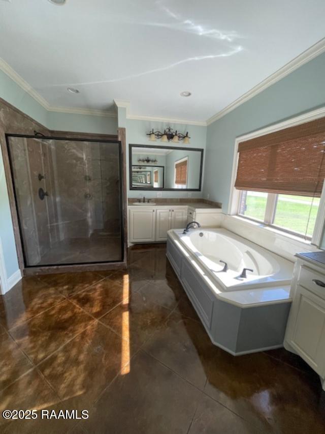 full bathroom featuring a shower stall, a garden tub, tile patterned flooring, ornamental molding, and vanity