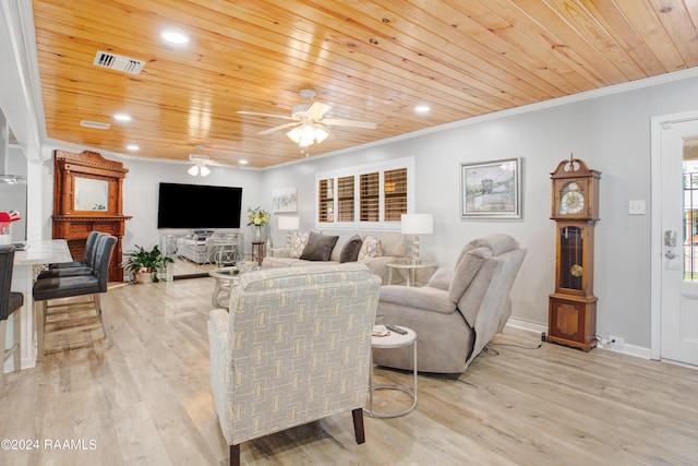 living room with crown molding, ceiling fan, light wood-style flooring, visible vents, and wood ceiling