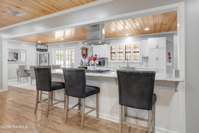 kitchen with wooden ceiling, island range hood, and ornamental molding