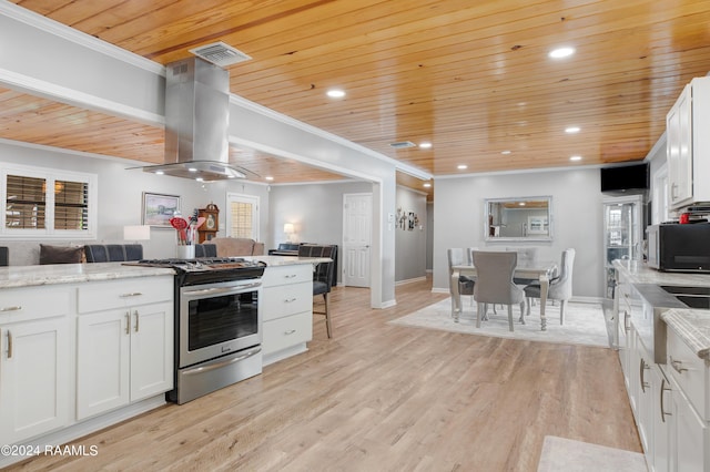 kitchen with light wood-style floors, stainless steel range with gas stovetop, visible vents, open floor plan, and island range hood