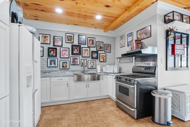 kitchen featuring a sink, white microwave, gas range, under cabinet range hood, and wooden ceiling