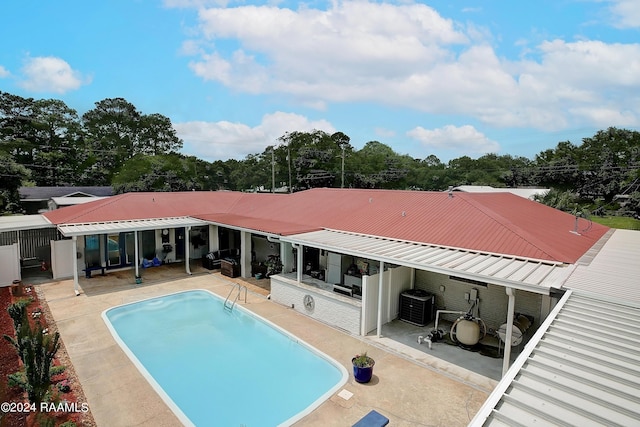 outdoor pool with a patio area and central AC