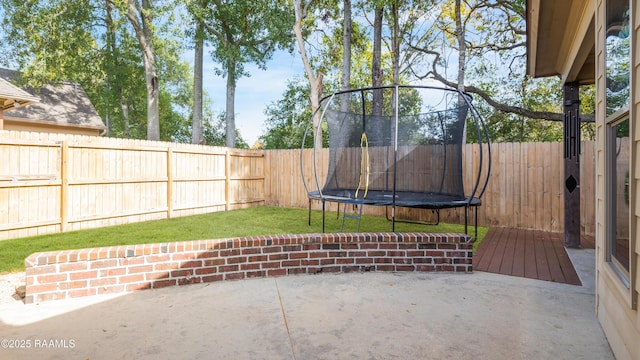 view of patio / terrace with a trampoline and a fenced backyard