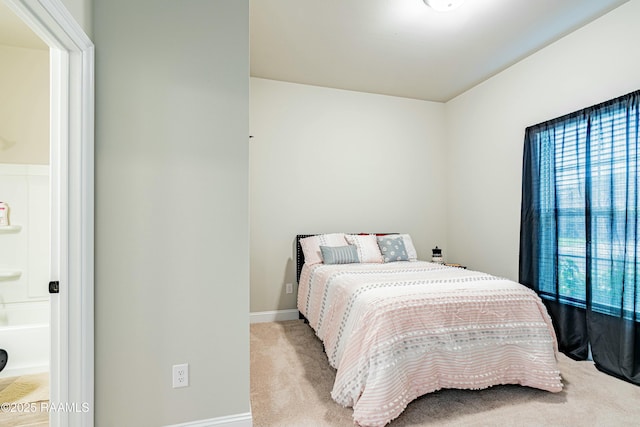 carpeted bedroom featuring baseboards