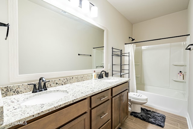 bathroom featuring toilet, shower / tub combo with curtain, a sink, and double vanity