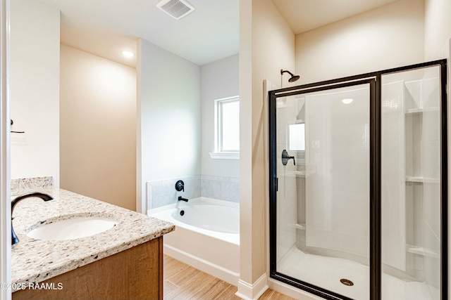 full bathroom with a garden tub, visible vents, vanity, and a stall shower