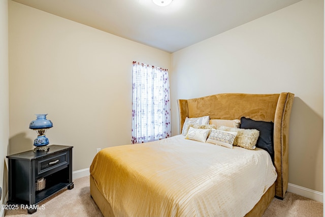 bedroom featuring light colored carpet and baseboards